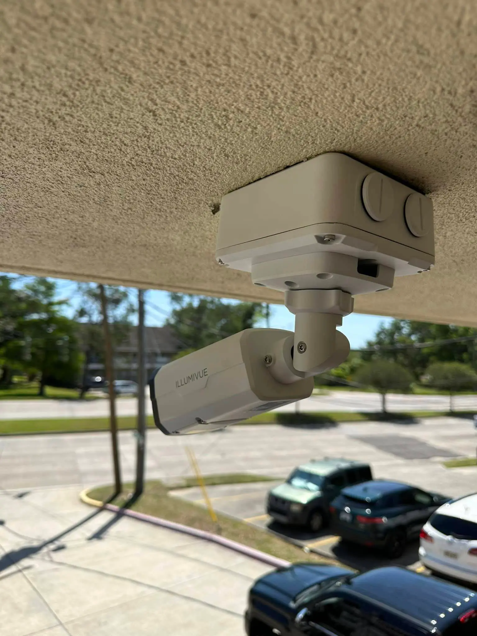 White Illumivue dome camera under a roof eave.