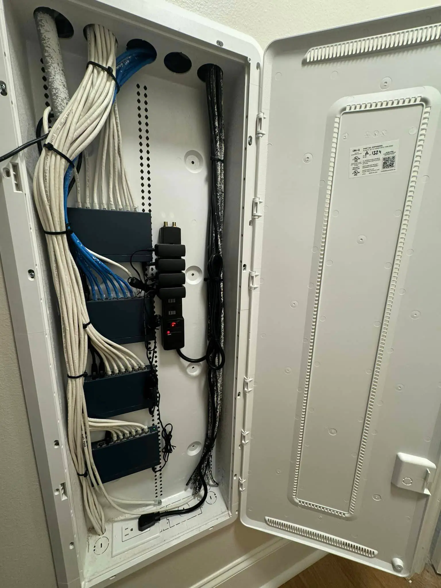 Labeled network and camera cables on a patch panel.
