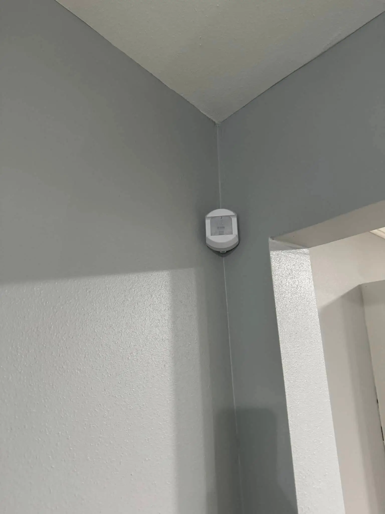Residential alarm, camera, or AV gear on the Westbank: interior tall photo, brighter toward the bottom.