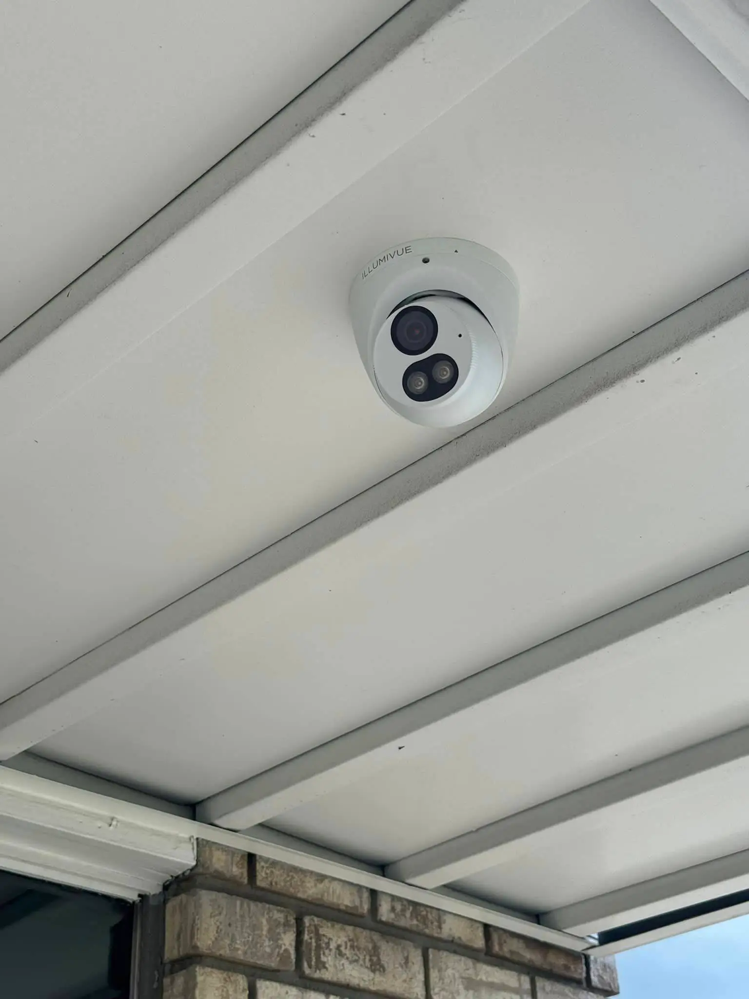 Residential alarm, camera, or AV gear on the Westbank: daylight tall photo, brighter toward the top.