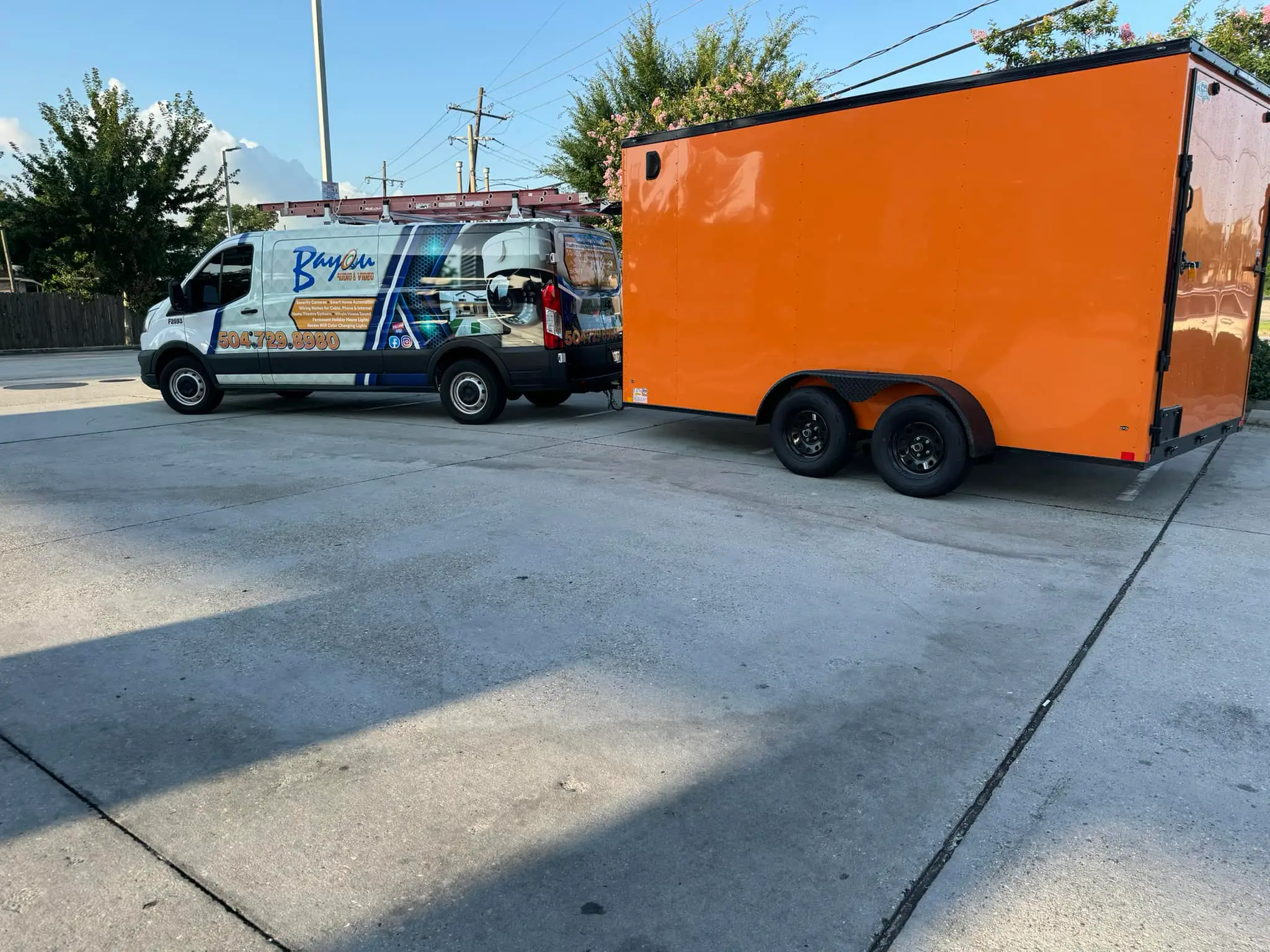 Two installers in front of the Bayou AV Security van.