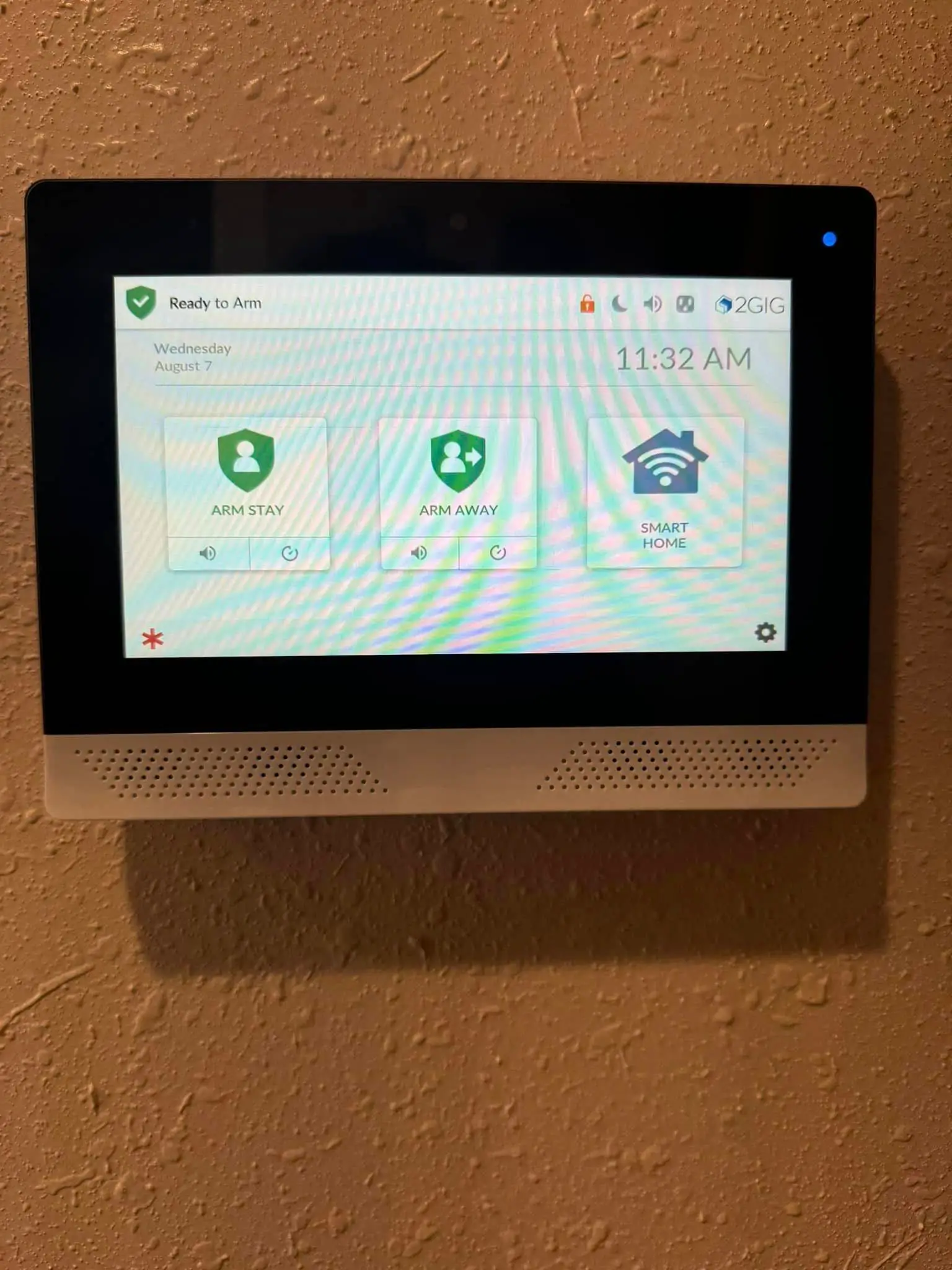Smart-home camera, keypad, or screen on the Westbank: interior tall photo, red light, brighter toward the top.