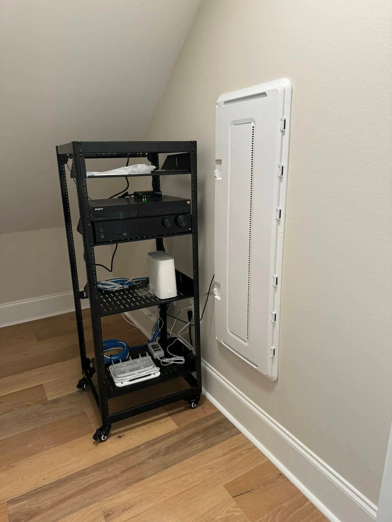 Whole-home speaker, screen, or rack on the Westbank: interior tall photo, warm light, brighter toward the top.