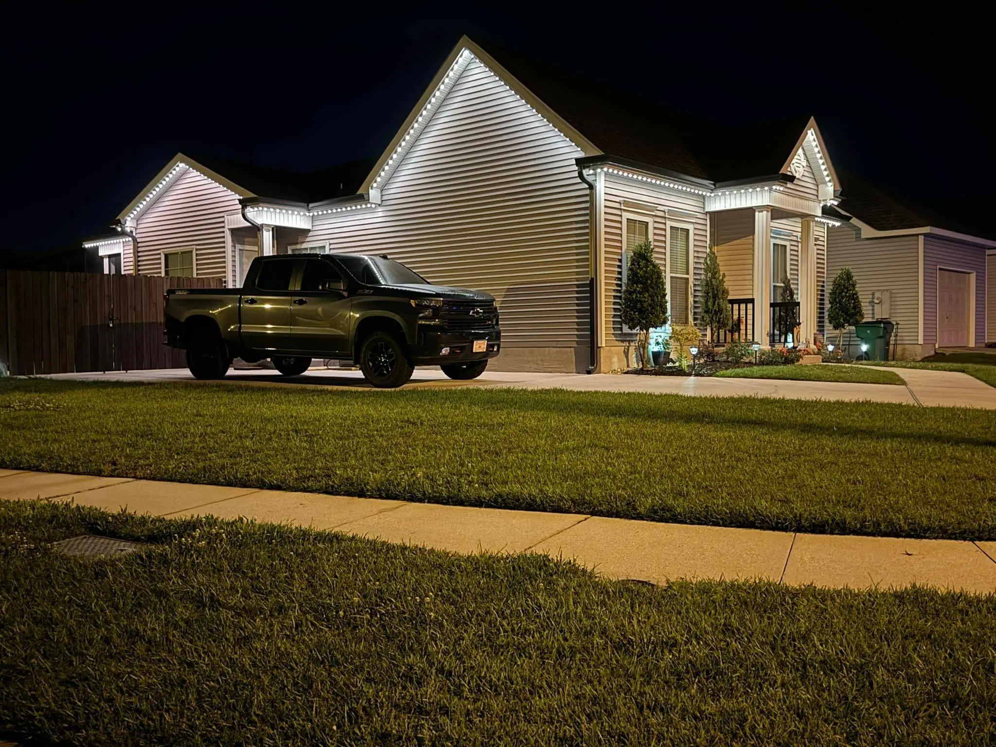 Trimlight on a Westbank house: night wide photo, warm light, even light across the frame.
