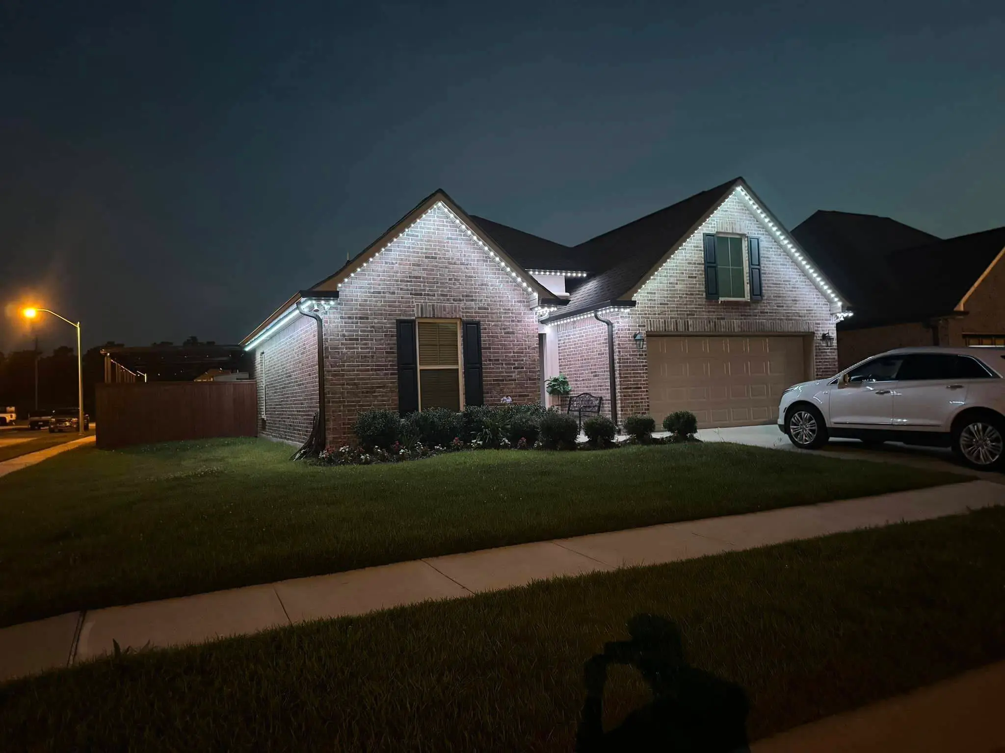 Trimlight on a Westbank house: night wide photo, brighter toward the top.