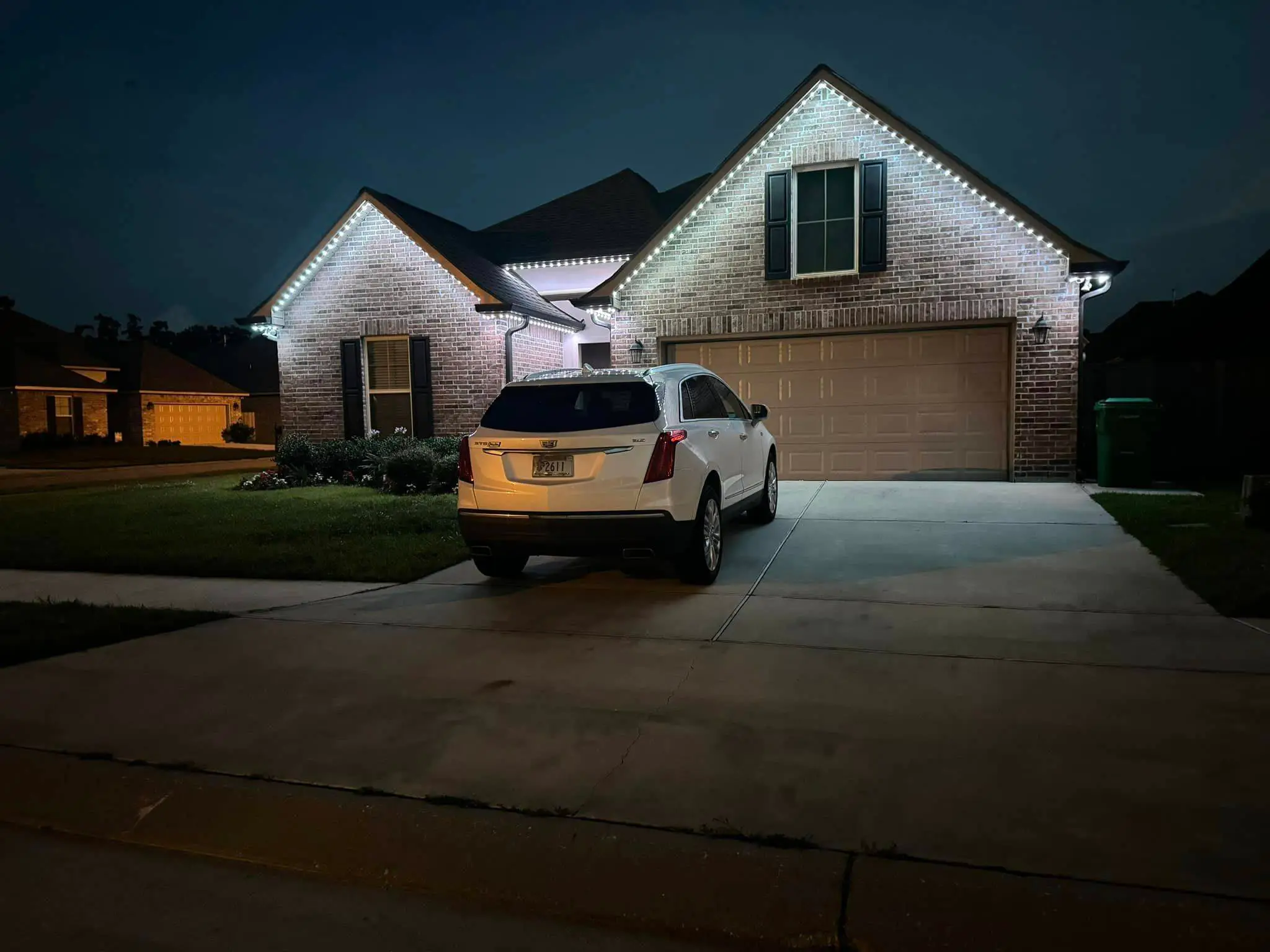 Trimlight on a Westbank house: night wide photo, brighter toward the top, photo 2.