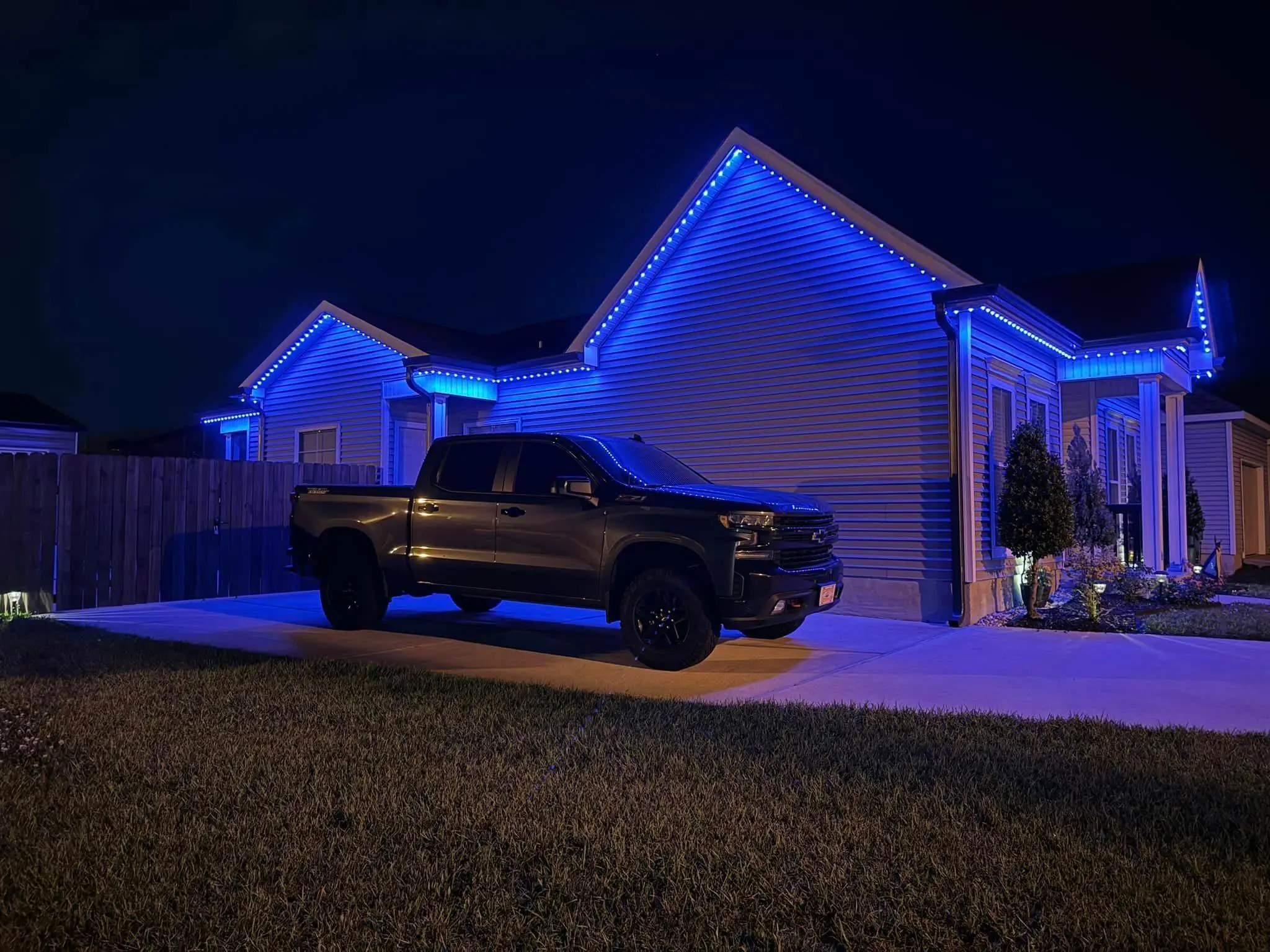 Trimlight on a Westbank house: night wide photo, blue light, even light across the frame.