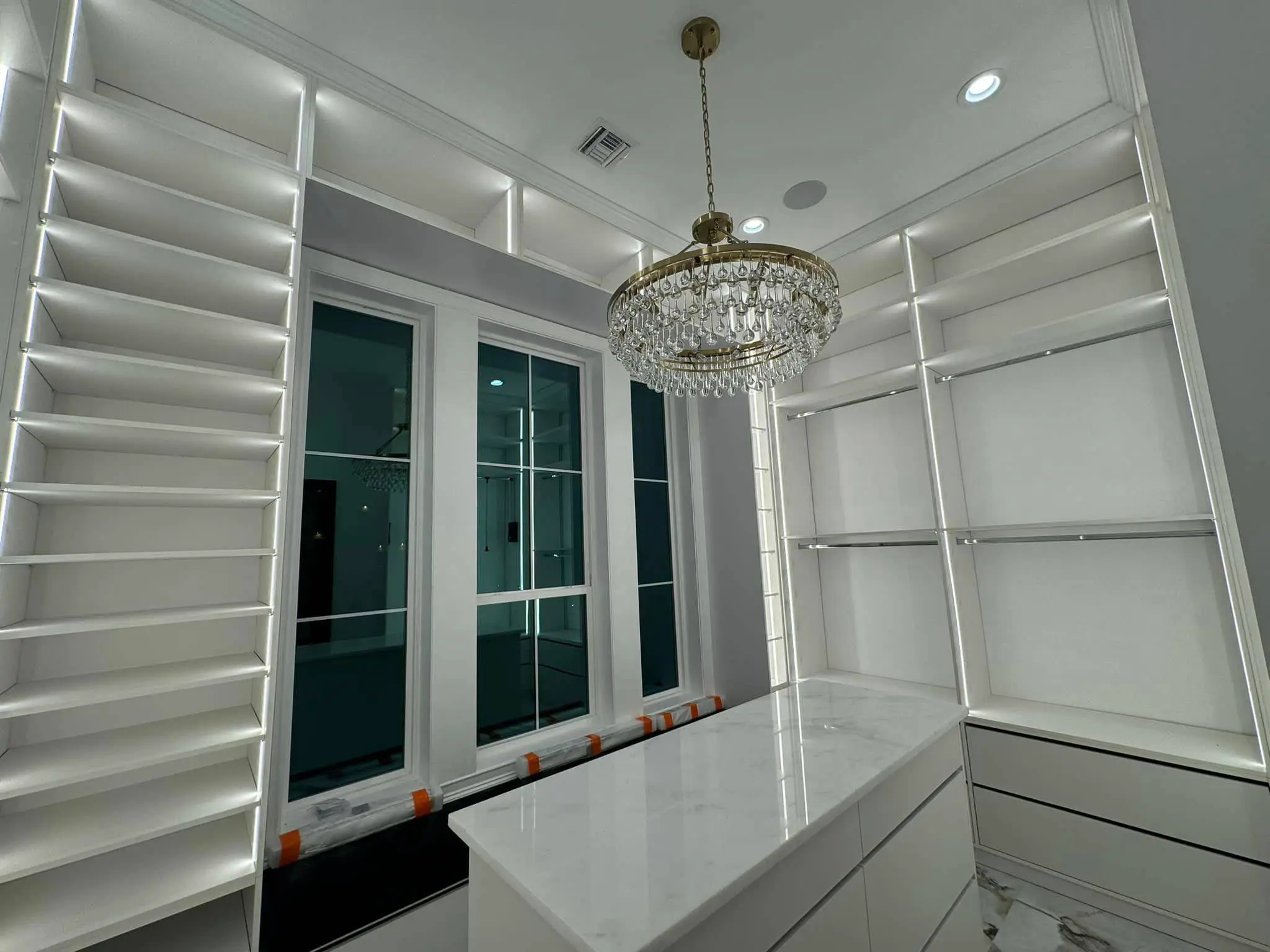 Under-cabinet lights in a Westbank kitchen: interior wide photo, brighter toward the top.