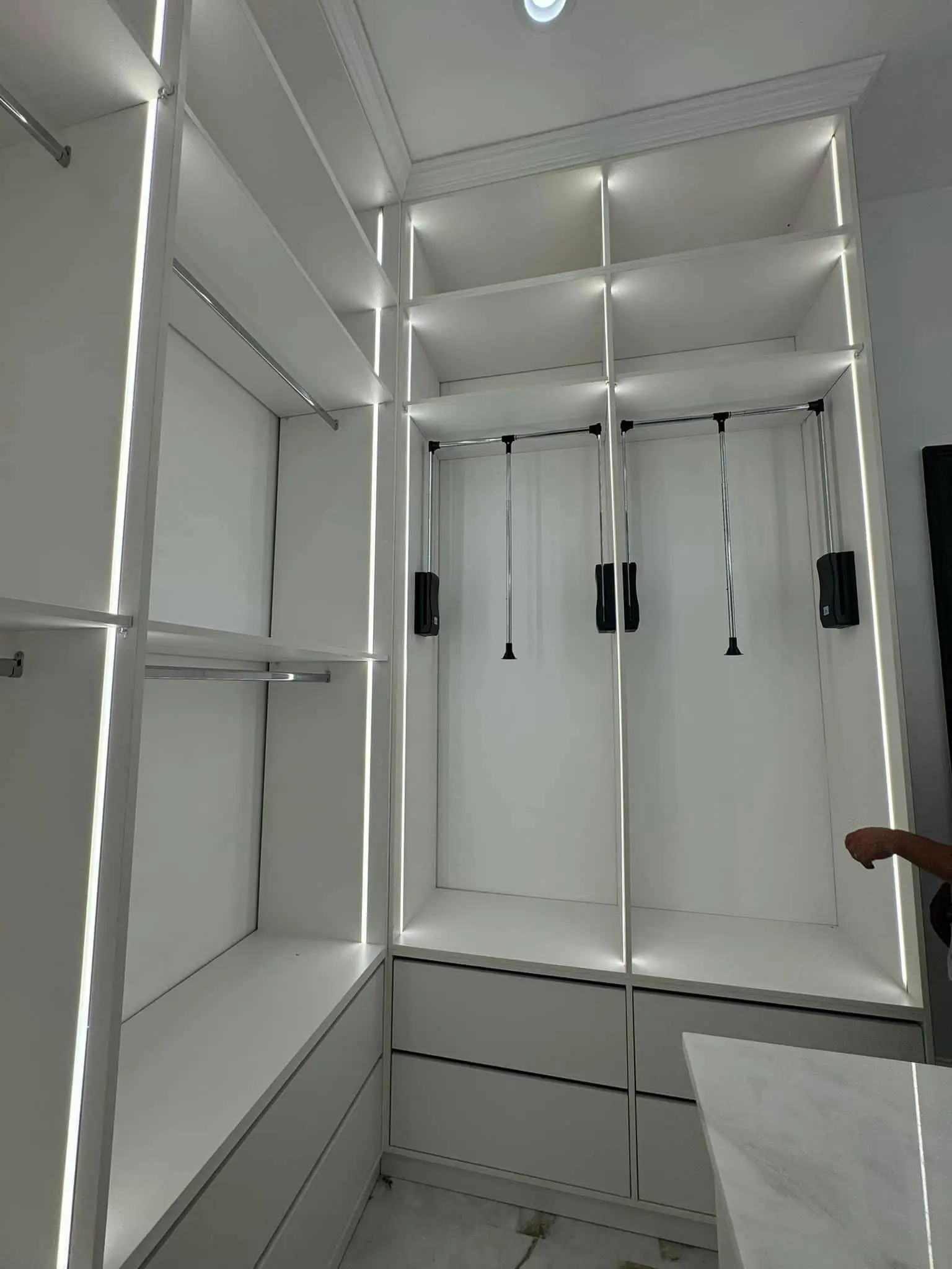 Under-cabinet lights in a Westbank kitchen: interior tall photo, even light across the frame.