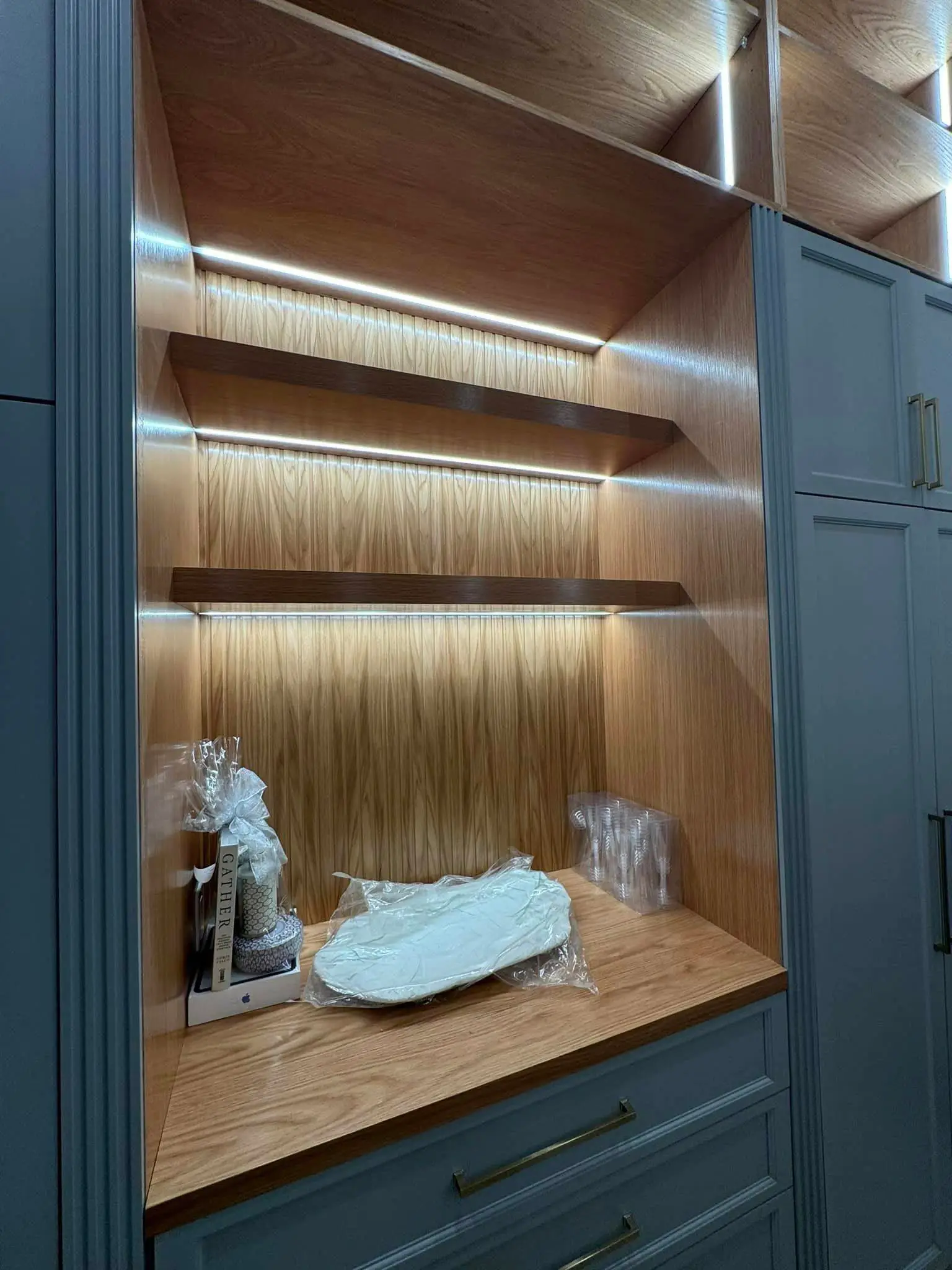 Under-cabinet lights in a Westbank kitchen: interior tall photo, even light across the frame, photo 6.