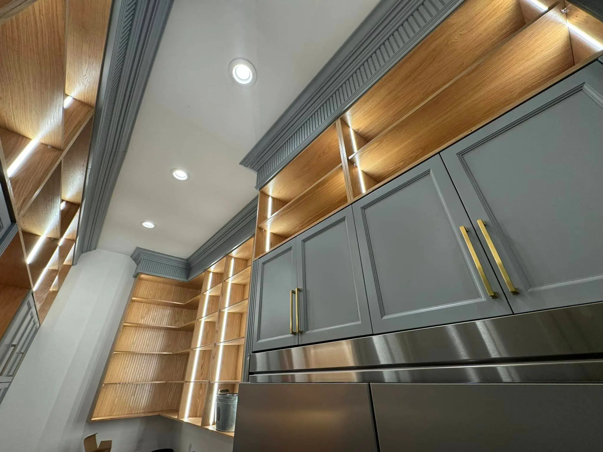 Under-cabinet lights in a Westbank kitchen: interior wide photo, warm light, brighter toward the top.